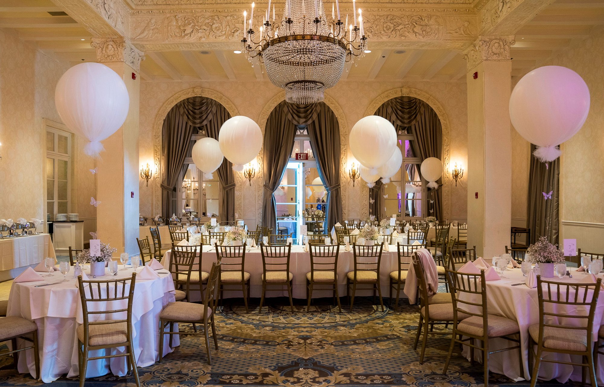 Ballroom celebration with balloons and chandeliers