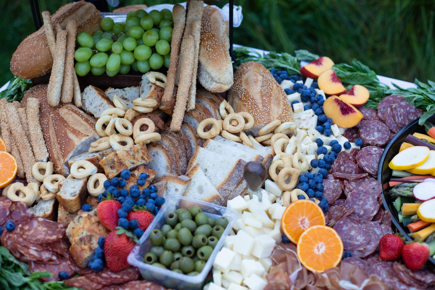 A grazing table styled with fruit, cheese, and bread